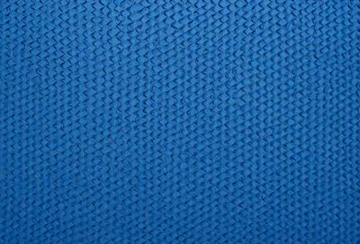 The primary subject of the image is a blue fabric with a pattern of interlocking diamond shapes. The setting is a blue background, and the visual style appears to be a digital art or illustration. The dominant colors are blue and white, creating a calm and soothing atmosphere.