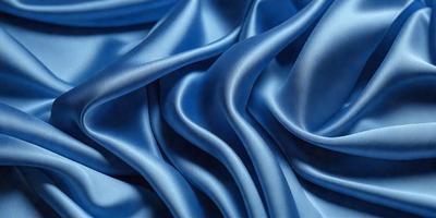 The primary subject of the image is a close-up of a blue fabric, possibly a piece of silk or a similar material. The setting is a room with a blue background, which adds to the overall atmosphere of the image. The visual style appears to be a close-up of the fabric, showcasing its texture and details. The colors and mood of the image are predominantly blue, creating a calm and serene atmosphere.