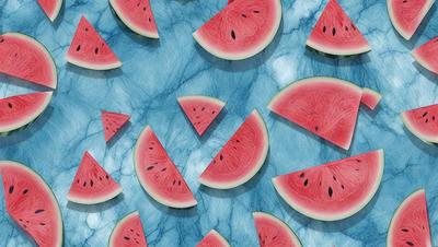 The primary subject of the image is a pattern of sliced watermelon on a blue marble surface. The watermelon slices are arranged in various shapes and sizes, creating a visually appealing and colorful display. The setting is a blue marble countertop, which serves as the backdrop for the watermelon pattern. The visual style of the image is a combination of photo and digital art, as it captures the vibrant colors and intricate details of the watermelon slices. The overall atmosphere of the image is fresh, lively, and inviting, with the blue marble surface adding a touch of elegance and sophistication to the presentation.