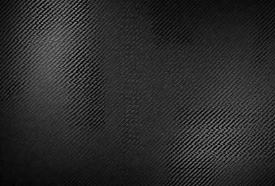 The primary subject of the image is a black and white patterned surface, which appears to be a black background with a pattern of white squares. The setting is a dark room, and the visual style is a close-up of the patterned surface. The colors and mood of the image are predominantly dark and moody, with the black and white pattern creating a sense of depth and contrast.