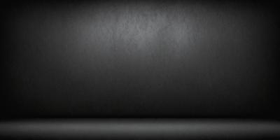 The primary subject of the image is a black wall with a gray background. The setting is a dark room, and the visual style is a black and white photo. The dominant colors are black and gray, creating a moody atmosphere.