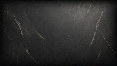 The primary subject of the image is a black marble countertop. The setting is a dark room, and the visual style is a close-up of the marble countertop. The countertop appears to be a dark grey color, giving it a sophisticated and elegant appearance.
