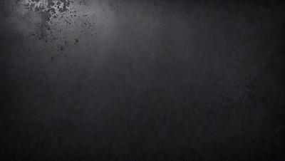The image is a black and white photo of a gray background. The primary subject is a large, empty space with no visible objects or people. The setting is a dark, moody atmosphere, and the visual style is a classic, timeless black and white photo. The colors and mood are predominantly dark and somber, creating a sense of emptiness and solitude.
