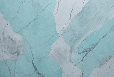 The primary subject of the image is a blue and white marble-like pattern on a wall. The setting is a room with a blue and white marble-like wallpaper. The visual style is a close-up of the wallpaper, showcasing the intricate design. The colors and mood of the image are predominantly blue and white, creating a clean and elegant atmosphere.