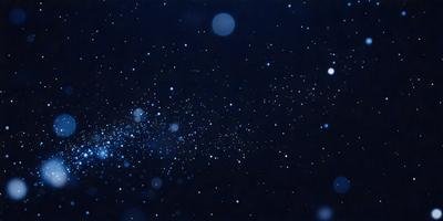The primary subject of the image is a cluster of bright, blue stars in the night sky. The setting is a dark, starry background, which contrasts with the brightness of the stars. The visual style is a photo of the night sky, capturing the beauty of the stars and their surroundings. The colors and mood of the image are predominantly dark and serene, with the bright blue stars standing out against the black background.