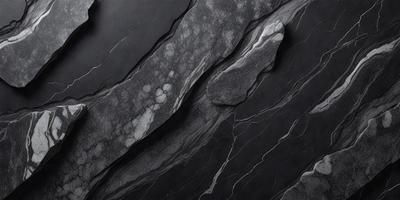 The primary subject of the image is a large, dark rock with a rough texture. The setting is a black and white photograph, which gives the image a classic and timeless appearance. The visual style is a close-up of the rock, emphasizing its intricate details and textures. The colors and mood of the image are predominantly dark and moody, with the black and white photography adding to the dramatic atmosphere.