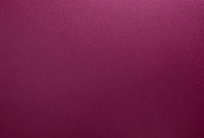 The primary subject of the image is a close-up of a purple wall. The setting is a room with a purple wall, and the visual style is a photo. The dominant colors in the image are purple and red, creating a warm and inviting atmosphere.