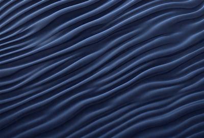 The primary subject of the image is a blue, wavy surface that resembles a wave or a ripple. The setting is a dark blue background, which contrasts with the blue surface. The visual style appears to be a digital art or illustration, as the surface has a smooth and detailed appearance. The dominant colors are blue, with a slightly darker shade, and the overall atmosphere is calm and serene.