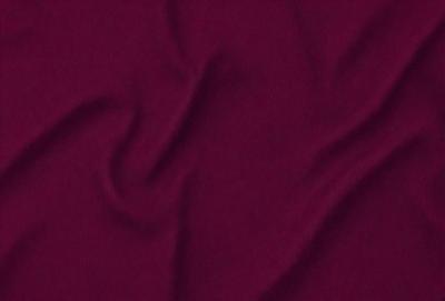The primary subject of the image is a close-up of a purple fabric. The setting is a room with a red background. The visual style is a photo of a purple fabric. The dominant colors are purple and red, creating a warm and vibrant atmosphere.
