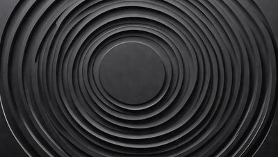 The primary subject of the image is a black circle, which is the main object, scene, or focus of the image. The setting or background is a black surface, and the visual style appears to be a photo. The colors and mood of the image are predominantly dark and moody, with the black circle being the most prominent element.