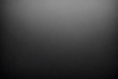The primary subject of the image is a black background with a gray sky. The setting is a cloudy sky, and the visual style is a black and white photo. The colors and mood of the image are dark and moody, creating a dramatic atmosphere.