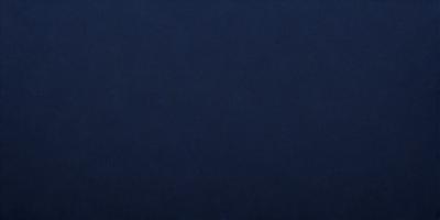 The primary subject of the image is a large, dark blue surface. The setting is a vast, empty space with no visible objects or backdrop. The visual style is a simple, monochromatic design. The dominant colors are shades of blue, creating a calm and serene atmosphere.