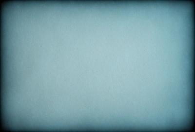 The primary subject of the image is a large, empty sheet of paper. The setting is a white background, and the visual style is a photo. The colors and mood of the image are predominantly blue, giving it a calm and serene atmosphere.