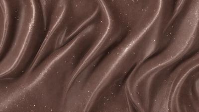 The primary subject of the image is a brown fabric with a pattern of white stars. The setting is a close-up of the fabric, showcasing its texture and pattern. The visual style is a close-up of the fabric, which gives it a detailed and textured appearance. The colors and mood of the image are predominantly brown and white, creating a warm and cozy atmosphere.