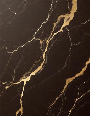 The primary subject of the image is a marble countertop with a gold-colored design. The setting is a kitchen, and the visual style is a close-up of the marble countertop. The colors and mood of the image are predominantly dark, with the gold accents adding a touch of warmth and sophistication.