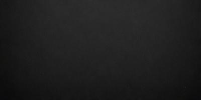 The primary subject of the image is a black background. The setting is a dark room, and the visual style is a black and white photo. The colors and mood of the image are dark and moody, creating a sense of mystery or drama.