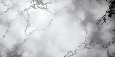 The primary subject of the image is a large, white, and textured surface, possibly a wall or a piece of art. The setting is a cloudy sky, which adds a dramatic and moody atmosphere to the scene. The visual style appears to be a combination of photo and digital art, creating a unique and intriguing appearance. The colors in the image are predominantly white, with some grays and possibly other colors depending on the specific details of the surface. Overall, the image evokes a sense of mystery and intrigue, with the cloudy sky and textured surface creating a captivating visual experience.