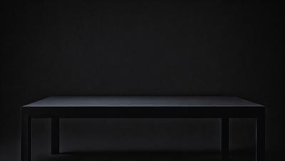 The primary subject of the image is a black bench. The setting is a dark room with a black wall behind the bench. The visual style is a black and white photo. The colors and mood of the image are predominantly dark and moody, with the black bench and black wall creating a sense of mystery and depth.