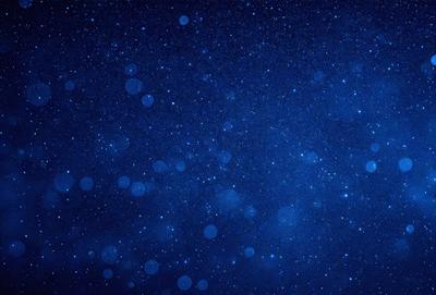 The primary subject of the image is the night sky, which is filled with a multitude of stars. The setting is a dark, star-filled sky, and the visual style is a photo of the night sky. The colors and mood of the image are predominantly dark and serene, with the stars providing a sense of depth and beauty.
