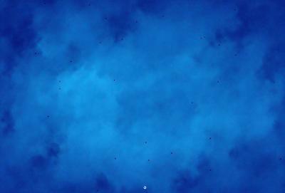 The primary subject of the image is a blue sky filled with white clouds. The setting is a cloudy day, and the visual style is a photo. The dominant colors are blue and white, creating a calm and serene atmosphere.