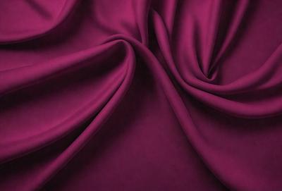 The primary subject of the image is a purple fabric, which is the main object, scene, or focus of the image. The setting or background is a purple curtain, and the visual style is a close-up of the fabric. The colors and mood of the image are predominantly purple, creating a calm and serene atmosphere.