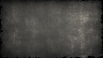 The primary subject of the image is a gray background with a texture that resembles a wall. The setting is a plain, empty space with no visible objects or people. The visual style is a black and white photo, giving it a classic and timeless appearance. The colors and mood are predominantly dark and moody, creating a sense of depth and contrast.