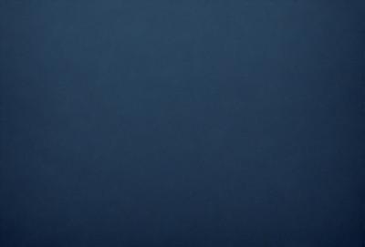 The primary subject of the image is a dark blue sky. The setting is a vast, open space with no visible landmarks or objects. The visual style is a natural, outdoor scene. The colors and mood are predominantly dark and moody, with the blue sky serving as the main focal point.