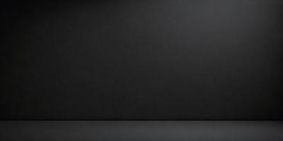The primary subject of the image is a black background. The setting is a dark room, and the visual style is a black and white photo. The colors and mood of the image are dark and moody, creating a sense of mystery or drama.