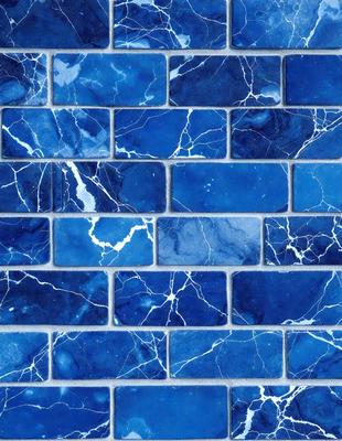 The primary subject of the image is a blue tile wall with a pattern of white and blue swirls. The setting is a room with a blue tile wall as the main focus. The visual style is a close-up of the blue tile wall, showcasing the intricate pattern of the swirls. The dominant colors are blue and white, creating a calm and soothing atmosphere.