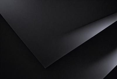 The primary subject of the image is a black square, which is the main object, scene, or focus of the image. The setting or background is a dark room, and the visual style is a photo. The colors and mood of the image are predominantly dark and moody, with the black square being the most prominent element.