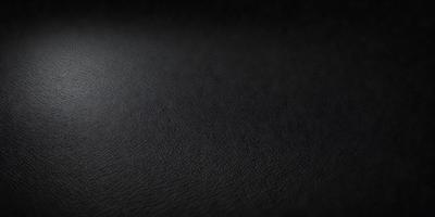 The primary subject of the image is a black leather surface. The setting is a dark room, and the visual style is a close-up of the leather surface. The colors and mood of the image are predominantly dark and moody, with the black leather being the main focus.