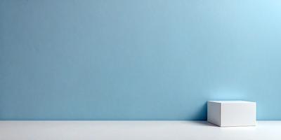 The primary subject of the image is a white box placed on a white surface. The setting is a blue wall, which serves as the backdrop for the box. The visual style of the image is a photo, capturing the box and the wall in a realistic manner. The colors and mood of the image are predominantly white and blue, creating a clean and calm atmosphere.