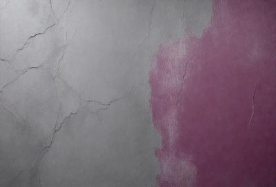 The primary subject of the image is a wall with a pink and white color scheme. The setting is a room with a grey and pink color palette. The visual style is a photo of a wall with a cracked texture. The dominant colors are pink and white, creating a warm and inviting atmosphere.
