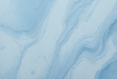 The primary subject of the image is a blue and white marble-like surface, which appears to be a wall or a countertop. The setting is a room with a blue and white color scheme. The visual style is a close-up of the marble-like surface, showcasing its intricate patterns and textures. The colors and mood of the image are predominantly blue and white, creating a calm and elegant atmosphere.