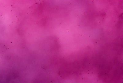 The primary subject of the image is a pink background with a purple hue. The setting is a cloudy sky, and the visual style appears to be a digital art or illustration. The colors and mood of the image are predominantly pink and purple, creating a warm and inviting atmosphere.