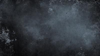 The primary subject of the image is a black and white photo of a wall. The setting is a dark room, and the visual style is a close-up of the wall. The colors and mood of the image are predominantly dark and moody, with the black and white color scheme adding to the atmosphere.