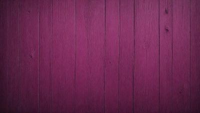 The primary subject of the image is a purple wooden wall. The setting is a room with a purple wall, and the visual style is a close-up of the wall. The dominant colors are purple and pink, creating a warm and inviting atmosphere.