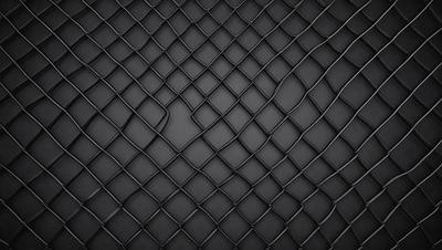 The primary subject of the image is a close-up of a black mesh material, which appears to be a woven or knitted fabric. The setting is a black background, which provides a stark contrast to the mesh material. The visual style is a close-up, focusing on the intricate details of the mesh. The colors and mood of the image are predominantly black, giving it a sleek and modern appearance.