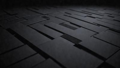 The primary subject of the image is a black and white patterned surface, which appears to be a black tile or a black and white checkered floor. The setting is a dark room, and the visual style is a close-up of the patterned surface. The colors and mood of the image are predominantly dark and moody, with the black and white pattern creating a sense of depth and contrast.