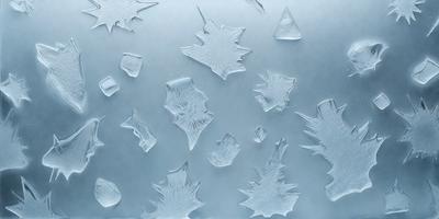 The primary subject of the image is a close-up of a leaf, which is the main object in the scene. The leaf is surrounded by a pattern of other leaves, creating a visually interesting and artistic composition. The setting appears to be a silver surface, which adds to the overall visual style of the image. The colors in the image are predominantly shades of blue, which contribute to a calm and serene atmosphere.