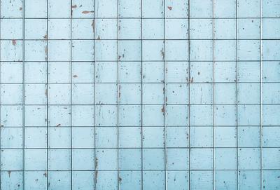 The primary subject of the image is a blue wall with a wooden texture. The setting is a room with a blue wall, and the visual style is a photo. The dominant colors are blue and brown, creating a calm and soothing atmosphere.