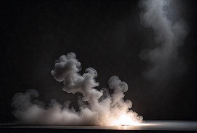 The primary subject of the image is a cloud of smoke, which is the main object, scene, or focus of the image. The setting is a dark room, and the visual style is a photo. The colors and mood of the image are predominantly dark and moody, with the smoke creating a dramatic and mysterious atmosphere.