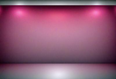The primary subject of the image is a large, empty stage with a purple backdrop. The setting is a theater or performance space, and the visual style is a photo. The dominant colors in the image are purple and pink, creating a moody and dramatic atmosphere.