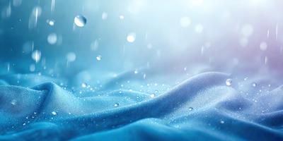 The primary subject of the image is a blue cloth with water droplets on it. The setting is a cloudy sky, and the visual style is a photo. The dominant colors are blue and white, creating a calm and serene atmosphere.