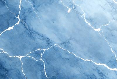 The primary subject of the image is a blue and white marbled wall. The setting is a room with a blue and white marbled wall, which serves as the background. The visual style is a painting, with the artist using a blue and white color palette to create a striking and visually appealing piece of art. The colors and mood of the image are predominantly blue and white, giving it a calm and serene atmosphere.