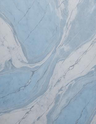 The primary subject of the image is a marble tile with a blue and white pattern. The setting is a wall, and the visual style is a photo. The dominant colors are blue and white, creating a calm and sophisticated atmosphere.