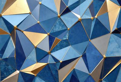 The primary subject of the image is a blue and gold geometric pattern. The setting is a blue background, and the visual style appears to be a combination of digital art and illustration. The dominant colors are blue and gold, creating a sense of depth and sophistication.