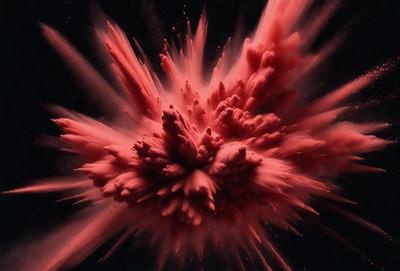 The primary subject of the image is a red splash or blur, which appears to be a painting or a digital artwork. The setting is a dark background, which contrasts with the red splash. The visual style suggests that the image is a digital artwork or a painting, rather than a photo. The dominant colors are red and black, creating a bold and striking atmosphere.