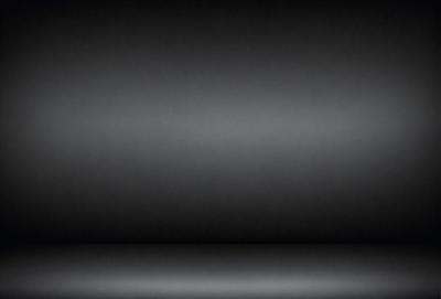 The primary subject of the image is a black background. The setting is a dark room, and the visual style is a black and white photo. The colors and mood of the image are predominantly dark and moody.
