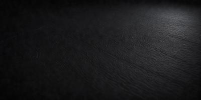The primary subject of the image is a black leather surface. The setting is a dark room, and the visual style is a close-up of the leather surface. The colors and mood of the image are predominantly dark and moody, with the black leather being the main focus.